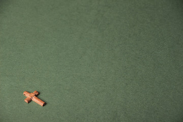 Christian cross on green background with space for writing © afanasyeva_t