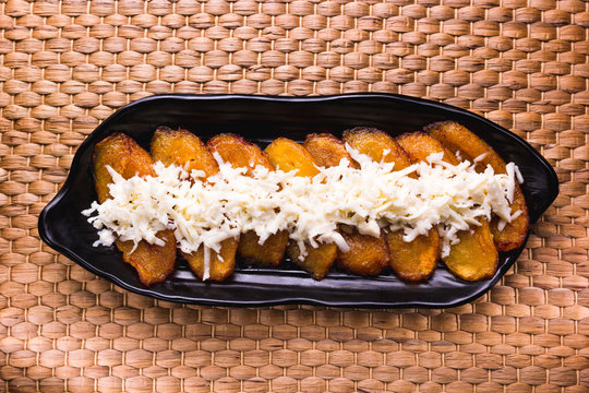 Fried plantain with cheese striped on top, South American food