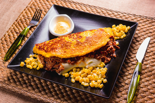 Cachapa, corn tortilla with cheese, meat and butter