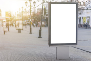 blank billboard on a street city center, banners with room to add your own text and advertising design. against the background of the setting sun