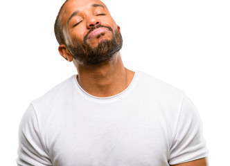 African american man with beard with sleepy expression, being overworked and tired isolated over white background