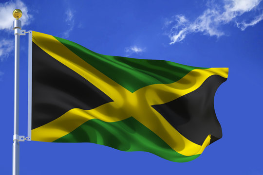 The silk waving flag of Jamaica with a flagpole on a blue sky background with clouds .3D illustration..