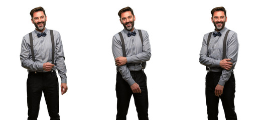 Obraz premium Middle age man, with beard and bow tie confident and happy with a big natural smile laughing