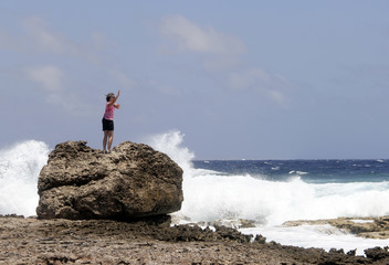 Fototapeta na wymiar Woman doing a yoga dance on an Ocean beach