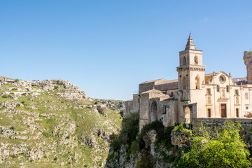 Fototapeta na wymiar Horizontal View of the Church of San Pietro Caveoso, in the Sassi of Matera on Blue Sky Background. Matera, South of Italy