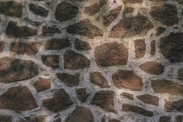 Texture of a wall from various stone blocks creating a pattern, background.