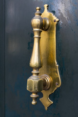 Door knocker close-up on a wooden wall 