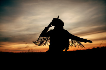 Boho nomads girl in field at Sunset