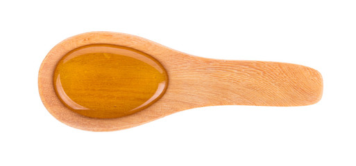 Sweet honey in wooden spoon isolated on white background
