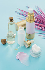 skincare beauty products concept image with pink palm leaf