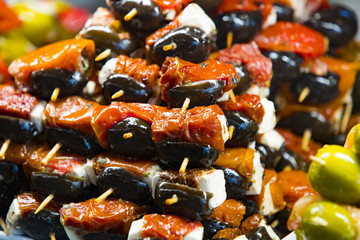 Skewers of cheese and seafood vegetables on the market of San Miguel for guests and residents of the city of Madrid.