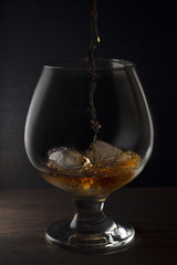 Cognac drinks glass on dark background