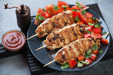 Lula kebabs made of chicken meat and served with fresh vegetables, studio shot, selective focus