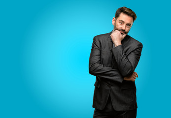 Middle age man, with beard and bow tie thinking thoughtful with smart face