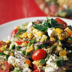 Colorful vegetable mix. Simple low calories salad. Cherry tomatoes, sweet corn, cucumber, bell pepper and cottage cheese. Weight loss dish. European cuisine. Toned photo.
