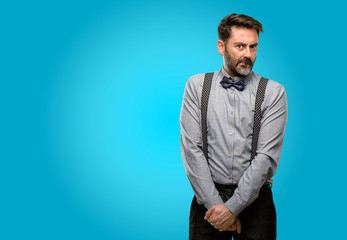 Middle age man, with beard and bow tie doubt expression, confuse and wonder concept, uncertain future