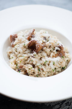 Close-up risotto with chanterelle mushrooms and grated parmesan, selective focus