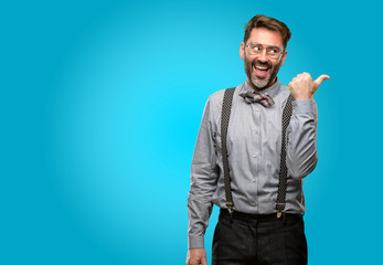 Fototapeta premium Middle age man, with beard and bow tie pointing away side with finger