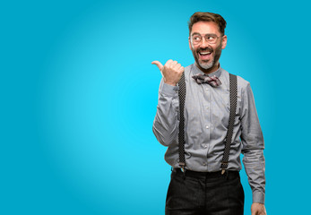 Naklejka premium Middle age man, with beard and bow tie pointing away side with finger