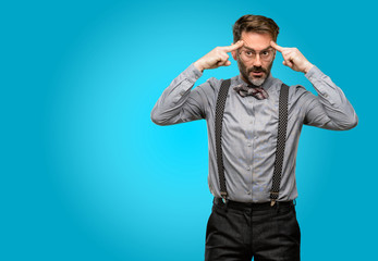 Middle age man, with beard and bow tie doubt expression, confuse and wonder concept, uncertain...