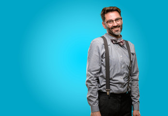 Obraz premium Middle age man, with beard and bow tie confident and happy with a big natural smile laughing, natural expression