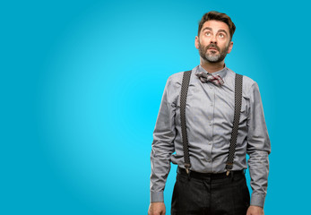 Fototapeta premium Middle age man, with beard and bow tie confident and happy with a big natural smile laughing looking up