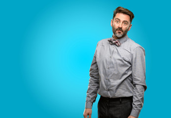 Fototapeta premium Middle age man, with beard and bow tie confident and happy with a big natural smile laughing