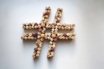 Wine corks hashtag symbol abstract composition isolated on white from a high angle view