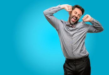 Fototapeta premium Middle age man, with beard and bow tie confident and happy with a big natural smile laughing