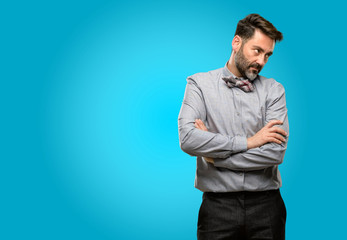 Middle age man, with beard and bow tie irritated and angry expressing negative emotion, annoyed with someone