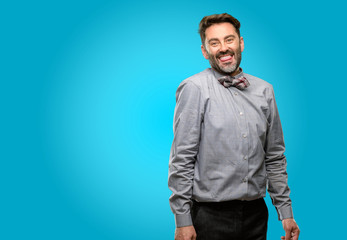 Middle age man, with beard and bow tie sticking out tongue at camera at sign of disobedience,...