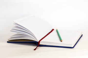 open notebook with pencil on white background