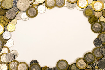 different coins money lie around the edges of the frame forming an area to insert text