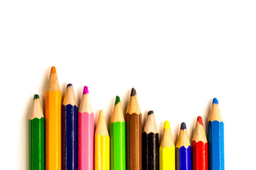 Fototapeta premium colored pencils lying on white background