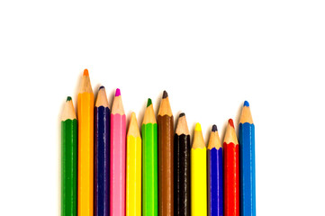 colored pencils lying on white background