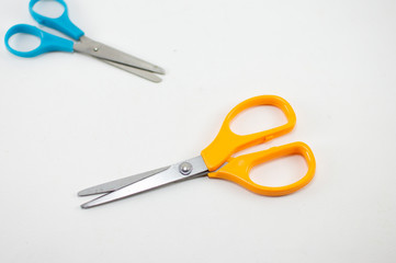 children's colorful scissors on a white background, for education.