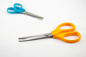 children's colorful scissors on a white background, for education.