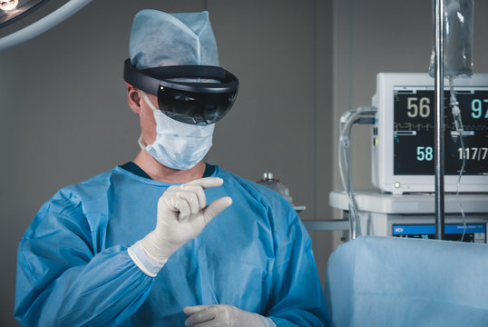 Surgeon using augmented reality holographic hololens glasses while operating in modern operation theater