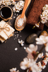 Spring Spa concept: sea salt, flowering cherry branches, towel, soap. Top view.