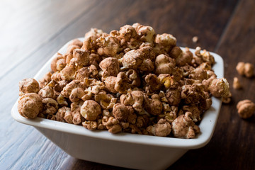 Chocolate Popcorn on dark Wooden Surface.