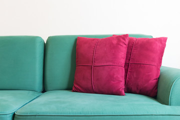 Green sofa and red backrest pillow in living room