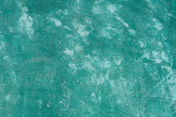 Cement wall is painted green color.