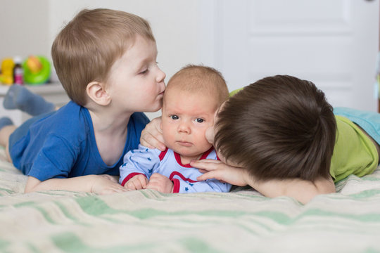 two brothers kissing younger brother
