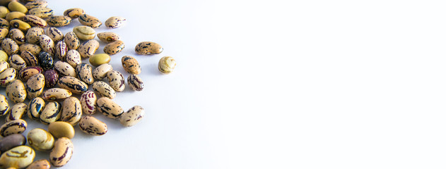 horizzontal picture with beans, the legumes are on white background
