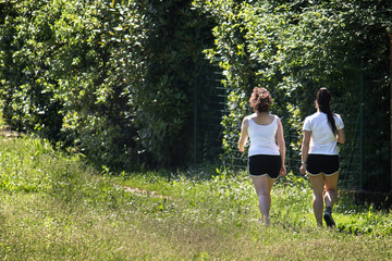 athletic girls rest during training, athletes walking at the park
