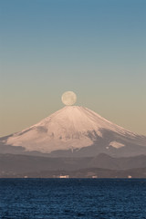 Fototapeta na wymiar Pearl Fuji , the setting moon meeting the summit of Mt. Fuji. Seen from Yokosuka coast , Kanagawa prefecture.