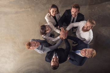 Business people putting their hands together. Concept of integration, teamwork and partnership