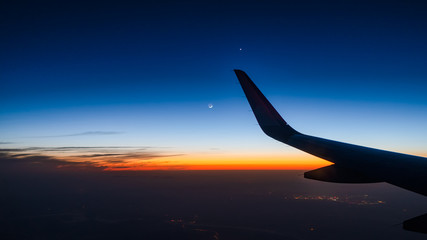 Plane travel sunset, moonset, and stars, world travel 