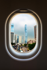Fototapeta na wymiar The window of airplane with travel destination attraction. Hongkong attraction