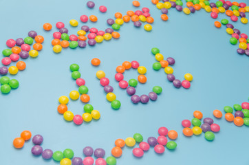 candy caramel lined word diet, on blue background, closeup